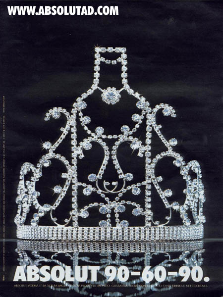 The tiara is resting on a reflective surface against a black background 