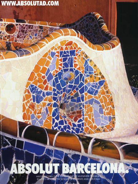 Mosaic tiles on a fountain in the shape of a bottle.