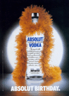Happy Birthday Absolut! Bottle with an orange boa around it's neck.