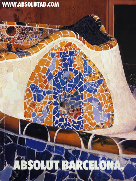 Mosaic tiles on a fountain in the shape of a bottle.