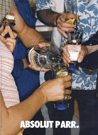 Group of people pouring Absolut at a party.