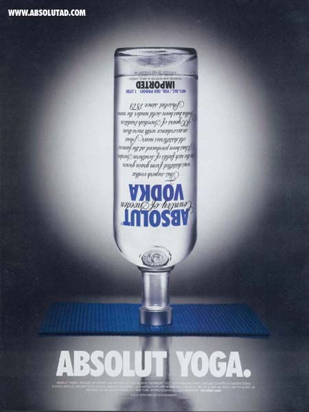 Absolut bottle upsie down on yoga mat.